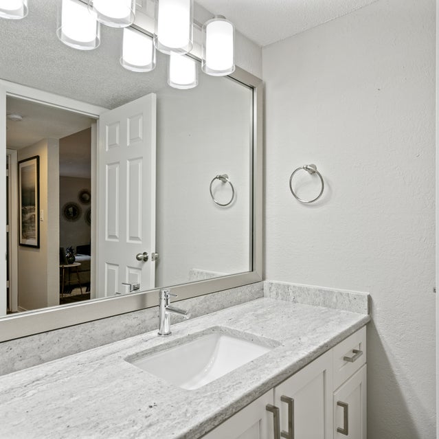 Andover At Crabtree Apartments - Bathroom With Granite Countertops And White Cabinets