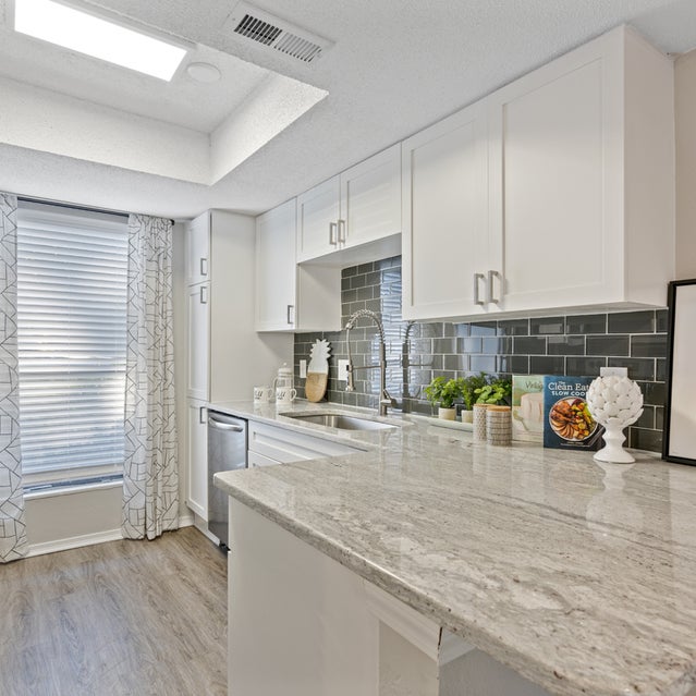 Andover At Crabtree Apartments - Kitchen With Stainless Steel Appliances, White Cabinetry And Dark Gray Subway Tile