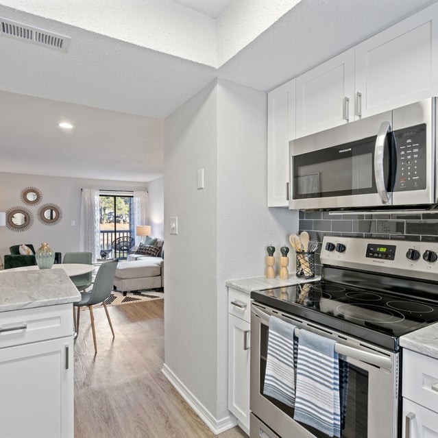 Andover At Crabtree Apartments - Open Concept Kitchen Overlooking Dining And Living Area