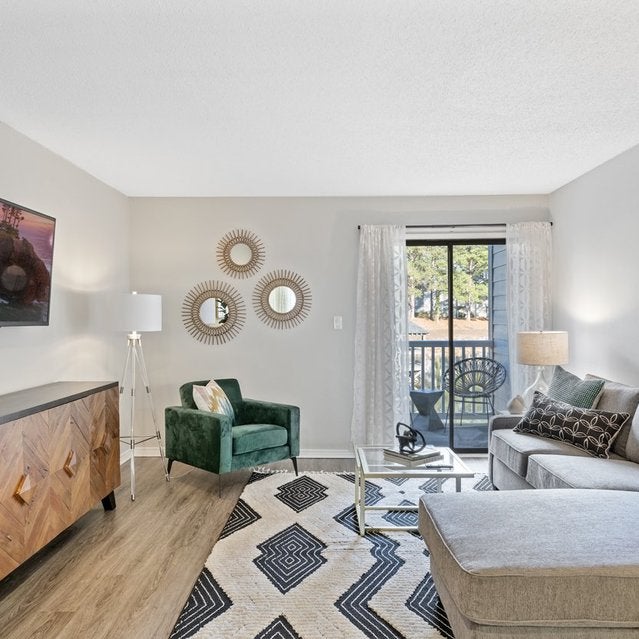Andover At Crabtree Apartments - Spacious Living Room With Wood-style Flooring And Door To Balcony