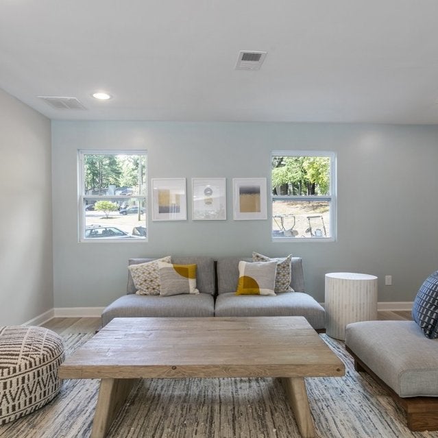 Andover at Crabtree Apartments - clubhouse with comfortable sofas and coffee table