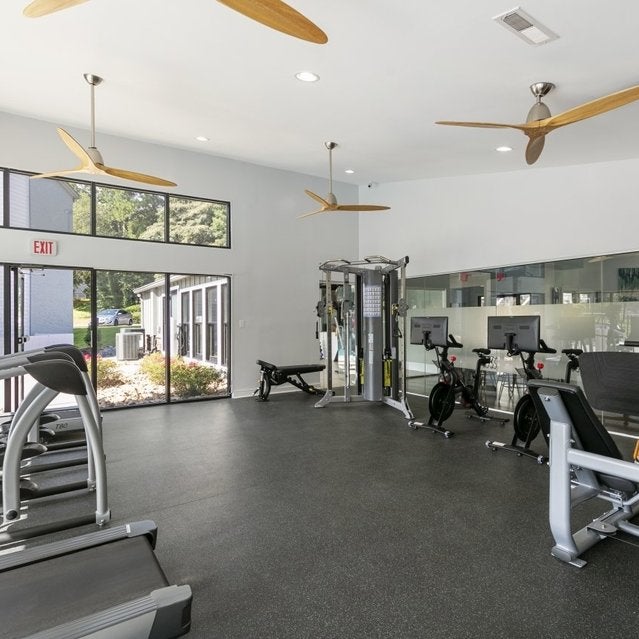 Andover at Crabtree Apartments - fitness center with cardio equipment and cable machines