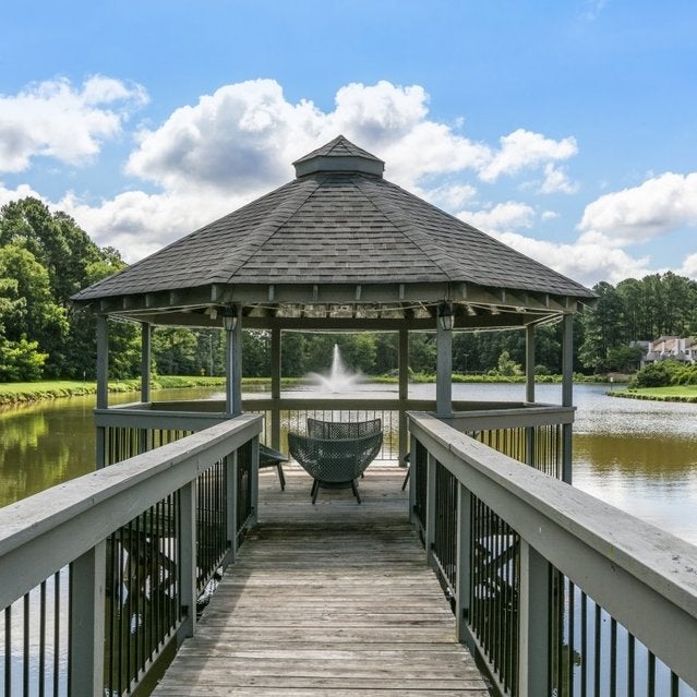 Andover at Crabtree Apartments - private lake with gazebo surrounded by trees