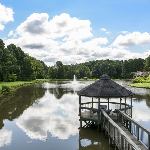 Andover at Crabtree Apartments - private lake with gazebo surrounded by trees