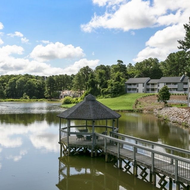 Andover at Crabtree Apartments - private lake with gazebo surrounded by trees