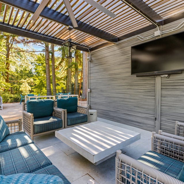 Andover at Crabtree - Covered outdoor seating area with TV